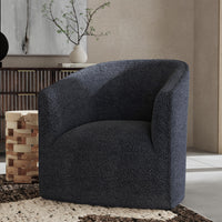 Blue wrapped-back swivel chair styled beside a patterned wood table and console