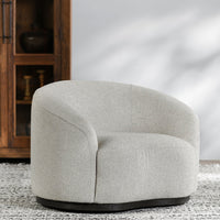 Coastal Breeze curved-back swivel chair styled on a patterned rug beside a cabinet