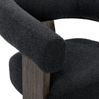 Close-up of the Charcoal chair's rounded upholstered arm and oak-veneered support