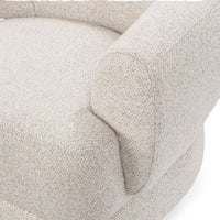 Close-up of the Dusty Beige chair's rounded arm, seat and upholstery seams