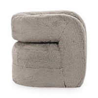 Side view of the Granite faux fur chair with a narrow opening beneath its rounded arm