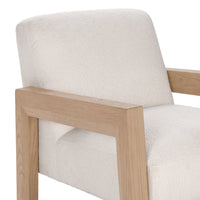 Close-up of the Ivory chair's broad oak arm and upholstered back