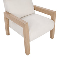 Angled seat detail of the Ivory chair with broad oak arms and front legs