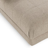 Close-up of the Buttermilk chair's rounded seat corner and upholstered base