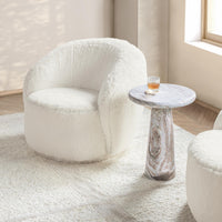 Vanilla swivel chair styled beside a small round table near a window