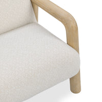 Close-up of the Sand chair's textured seat and curved wood arm