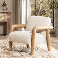 Sand wood-arm chair styled on a patterned rug beside a large window