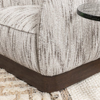 Cocoa Cream chair arm and dark wood base shown close-up beside a side table