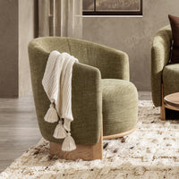 Sage Dust accent chair styled with a white tasseled throw on a patterned rug