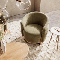 Overhead view of the Sage Dust chair styled beside a small table on a patterned rug