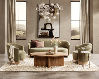 Two Sage Dust accent chairs styled with a sofa and round wood coffee table
