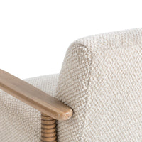 Close-up of the Beige Natural chair's wood arm, ribbed post and textured back