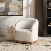 Toasted Linen swivel chair styled on a patterned rug beside a small side table