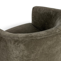 Overhead detail of the Olive Moss chair's curved back and stitched upper edge