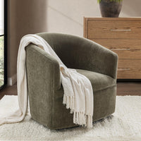 Olive Moss wrapped-back swivel chair styled with a white throw on a pale rug