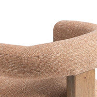 Close-up of the Desert Clay chair's curved upholstered back and rear wood support