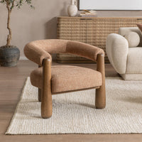 Desert Clay horseshoe-back chair styled on a pale rug beside a sofa