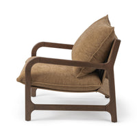 Side view of the Honey Oat chair with a reclined back cushion and curved wood arms