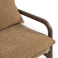 Close-up of the Honey Oat chair's seat cushion and curved wood arm
