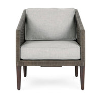 Front view of the gray rattan chair with pale cushions and slim tapered legs