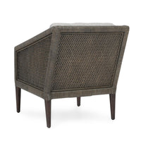 Rear three-quarter view of the gray rattan chair with woven back and side panels