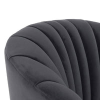 Close-up of channels following the gray chair's curved back and arm