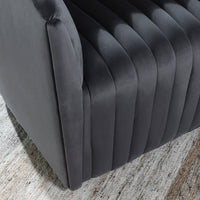 Close-up of the gray chair's channel-tufted seat and front edge