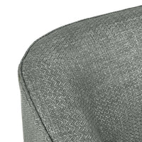 Close-up of the dark gray chair's curved back seam and fine woven upholstery