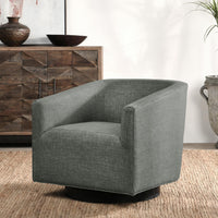 Dark gray swivel chair styled on a woven rug beside a wooden cabinet
