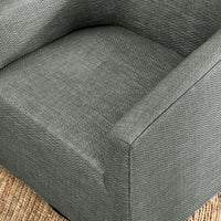 Elevated detail of the dark gray chair's seat and sloping arms