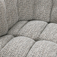 Close-up of the Heathered Gray chair's tufted seat and textured fabric