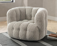 Heathered Gray tufted swivel chair styled on a striped rug