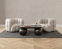 Two Heathered Gray tufted swivel chairs arranged around a low coffee table