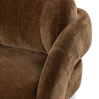 Close-up of the Bronze chair's rounded arm and upholstered back