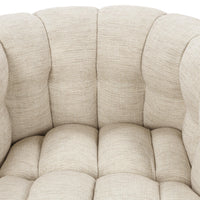 Close-up of the beige chair's tufted inner back and seat