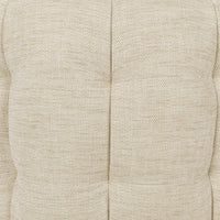Detail of the beige chair's woven upholstery and recessed tufting seams