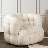 Beige tufted swivel chair styled beside a rug against a paneled wall