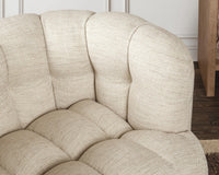 Beige chair arm and seat tufting shown close-up in a room setting