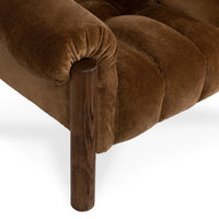 Close-up of the Bronze chair's gathered arm upholstery around an oak front post