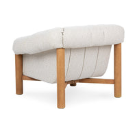 Rear three-quarter view of the Cream chair with vertical back seams and oak supports