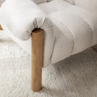 Cream channel-tufted seat and rolled arm detail, styled on a pale rug