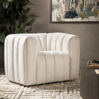 Cream channel-tufted swivel chair styled on a patterned rug beside a low table