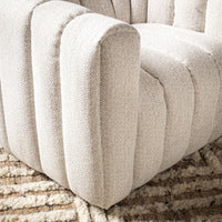 Cream chair arm and seat channels shown close-up on a patterned rug