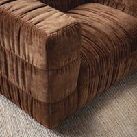 Bronze chair arm and seat detail, styled on a woven rug
