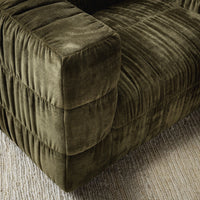 Olive Green chair arm and seat detail, styled on a woven rug