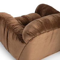 Elevated rear detail of the Bronze chair's rounded back and gathered arm upholstery