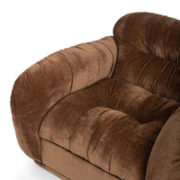 Close-up of the Bronze chair's gathered seat, rounded arm and padded back