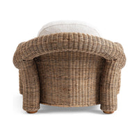 Rear view of the Natural rattan chair with a rounded woven back and thick legs