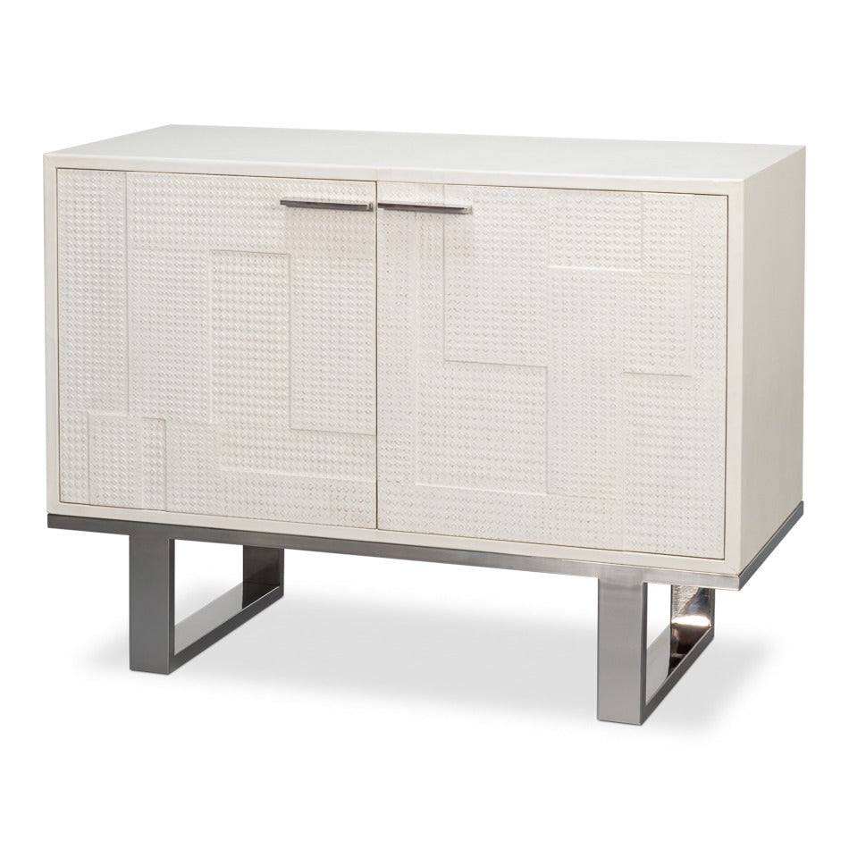 Small embossed white credenza with textured ivory doors and polished metal sled base