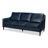 Contemporary three-cushion sofa in deep chateau blue leather with slim track arms and tapered dark wood legs